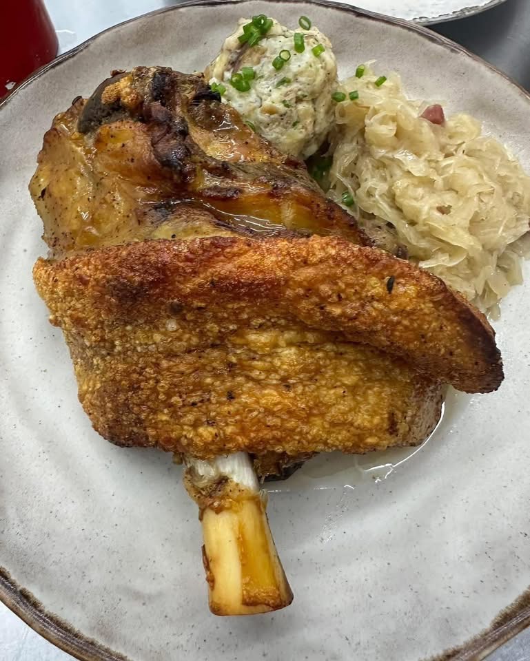 Crispy pork knuckle with sauerkraut and a bread dumpling
